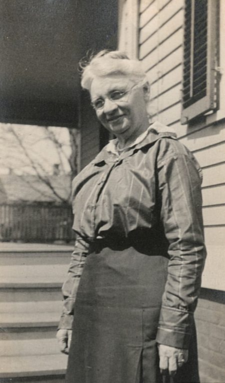 A photo of Minna Fernald outside of a house