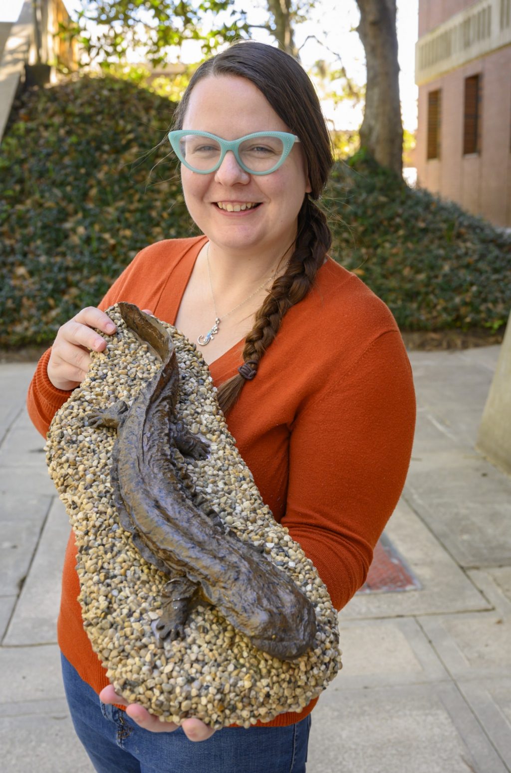 woman holds cast of hellbender