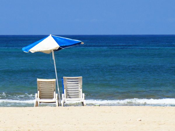 empty beach with lounge chairs