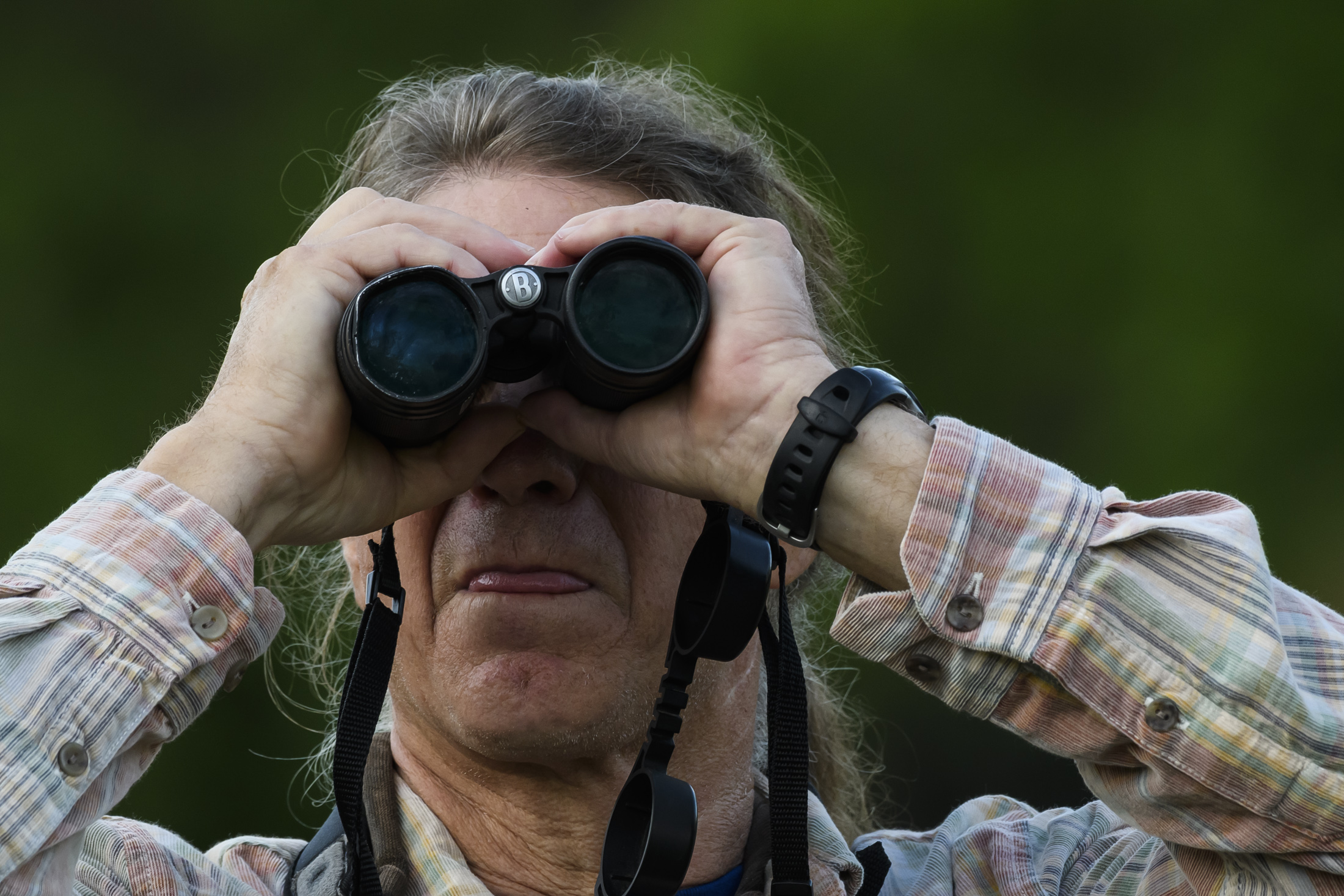 Andy Kratter looking through binoculars