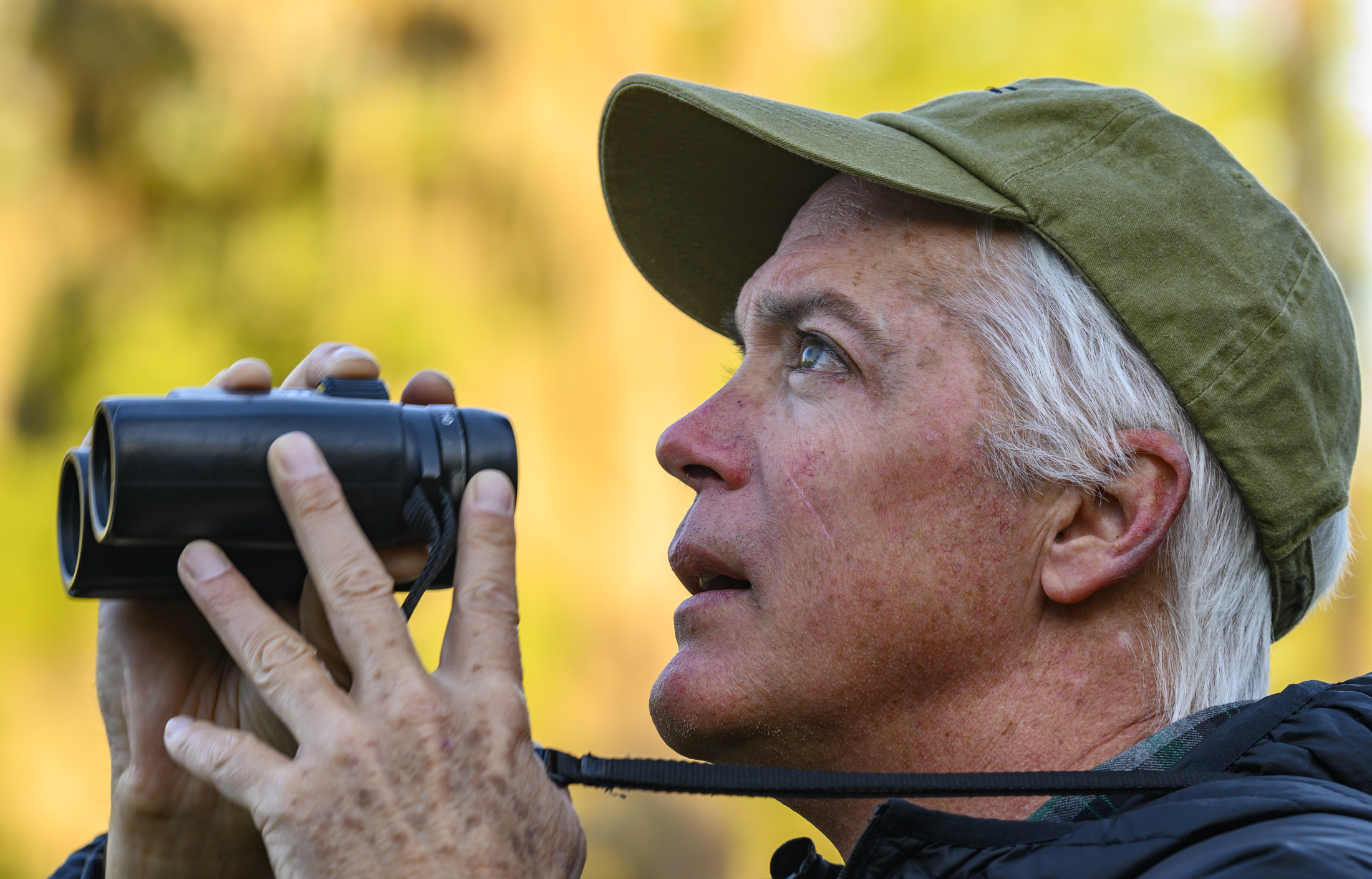 Adam Kent holding binoculars