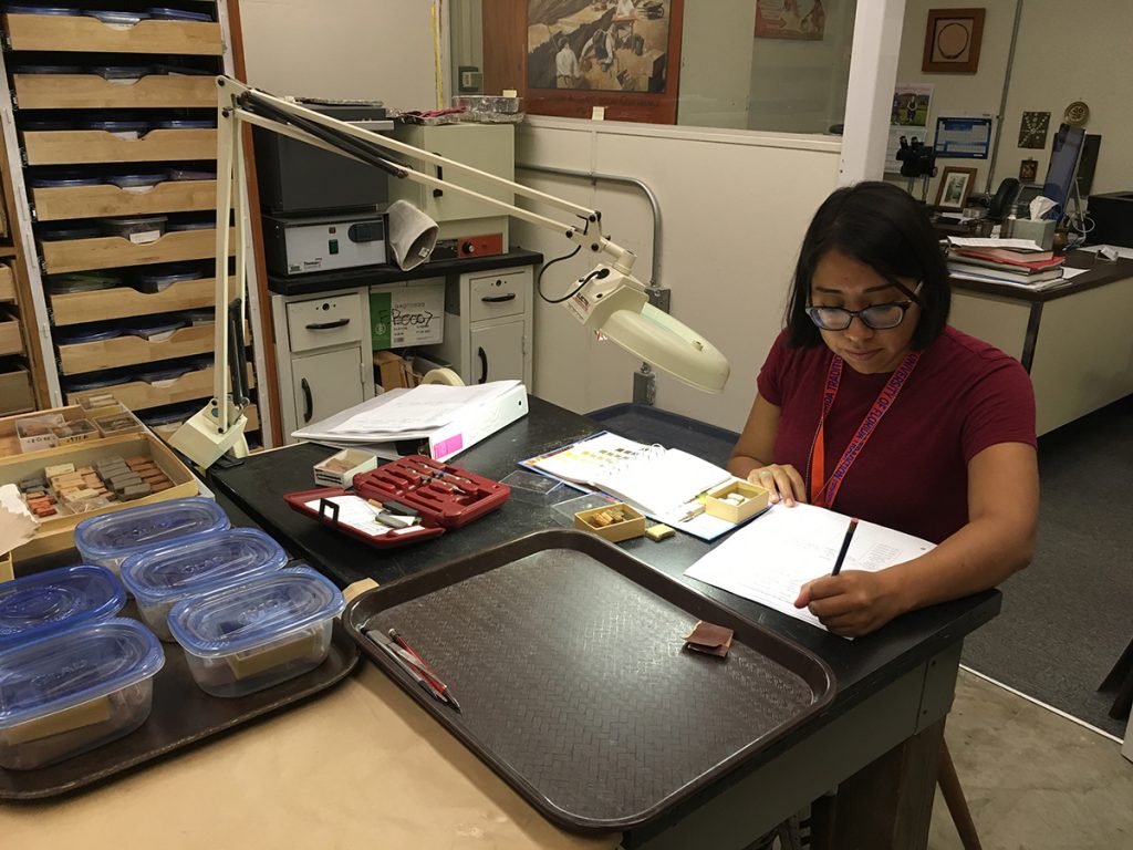 woman scores color of clay bricks