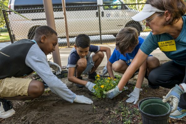 group of people planting flowers