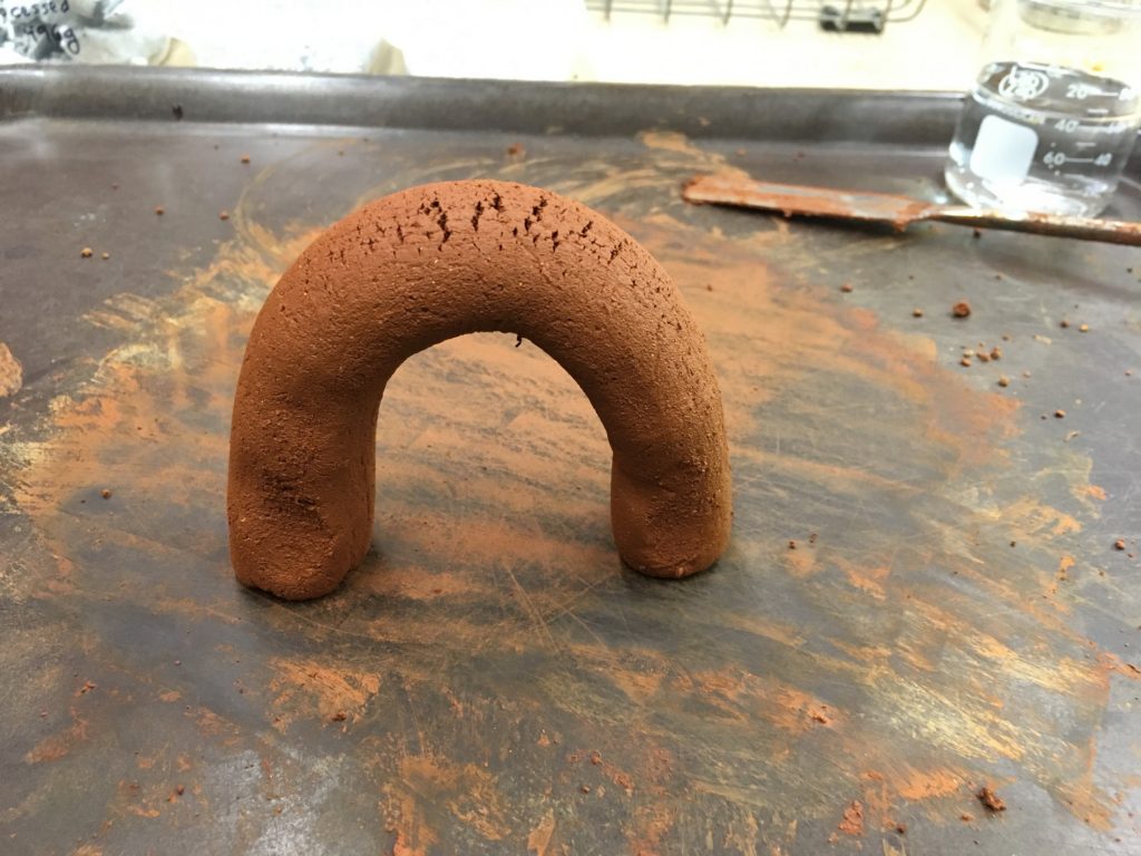 Aggregated clay rolled into a cylinder and twisted to test its durability