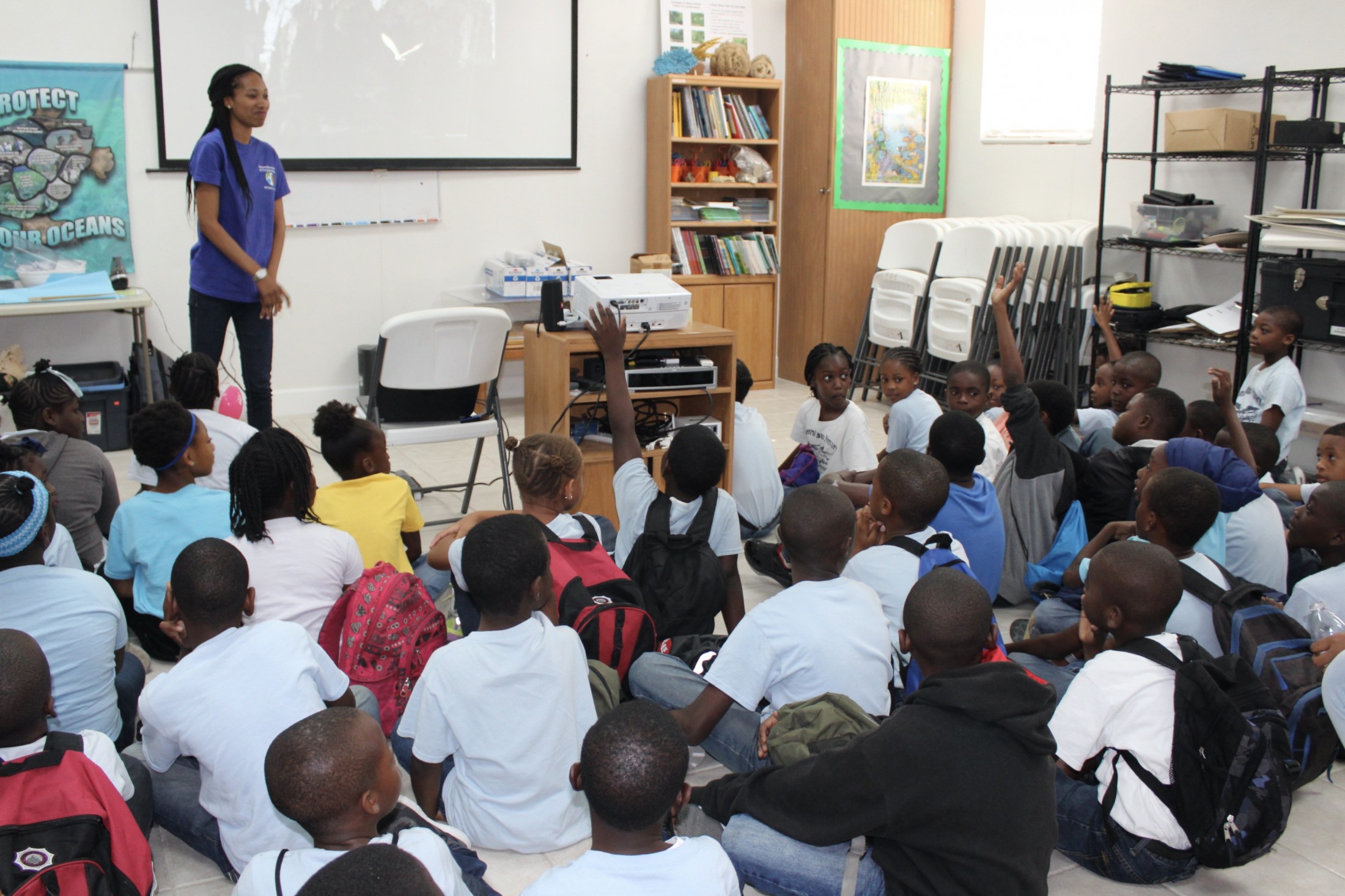 Kelly Fowler gives a presentation to students on ecosystems past and present to a group of schoolchildren.