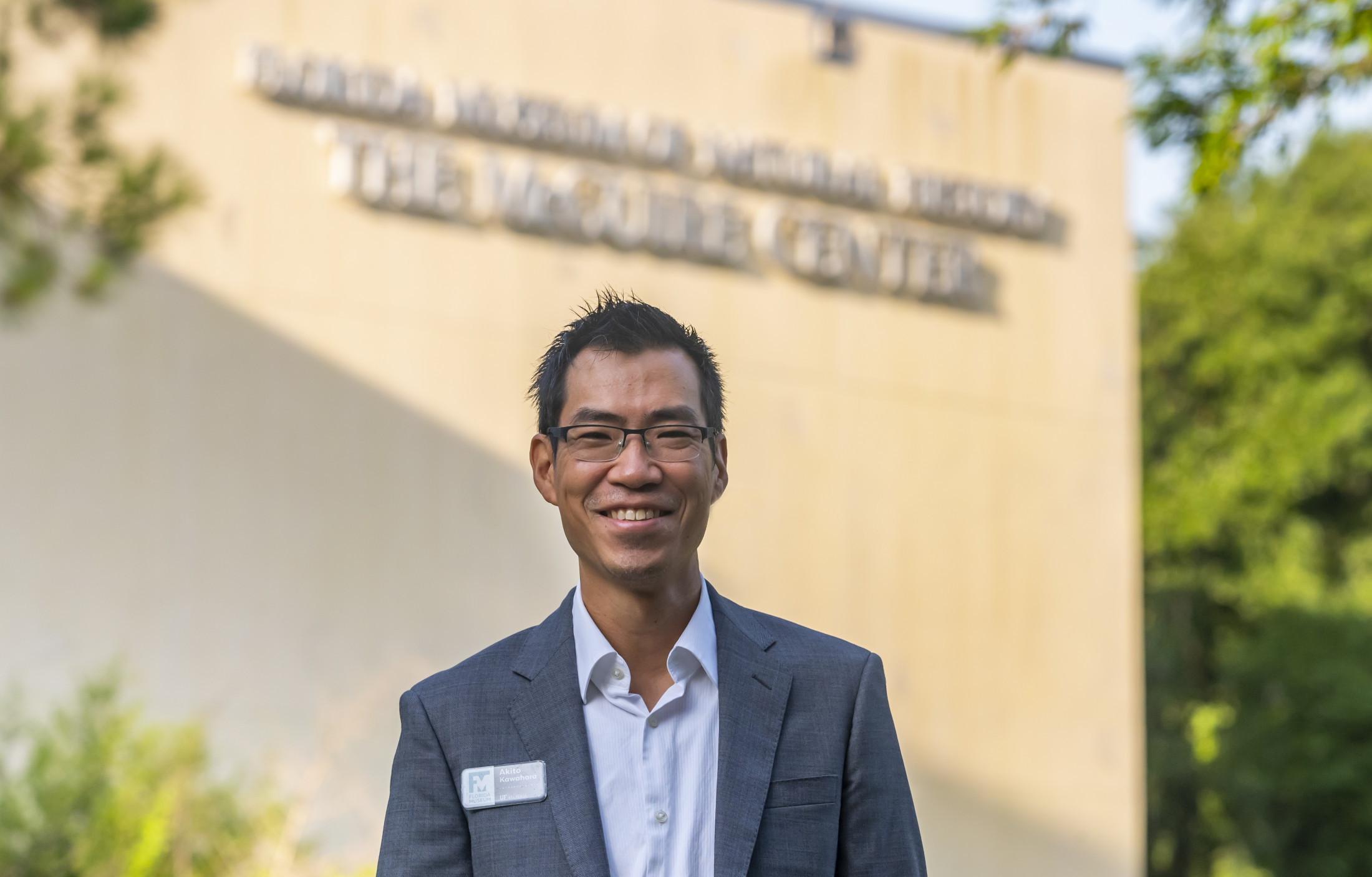 Akito Kawhara smiles while standing in front of The McGuire Center.
