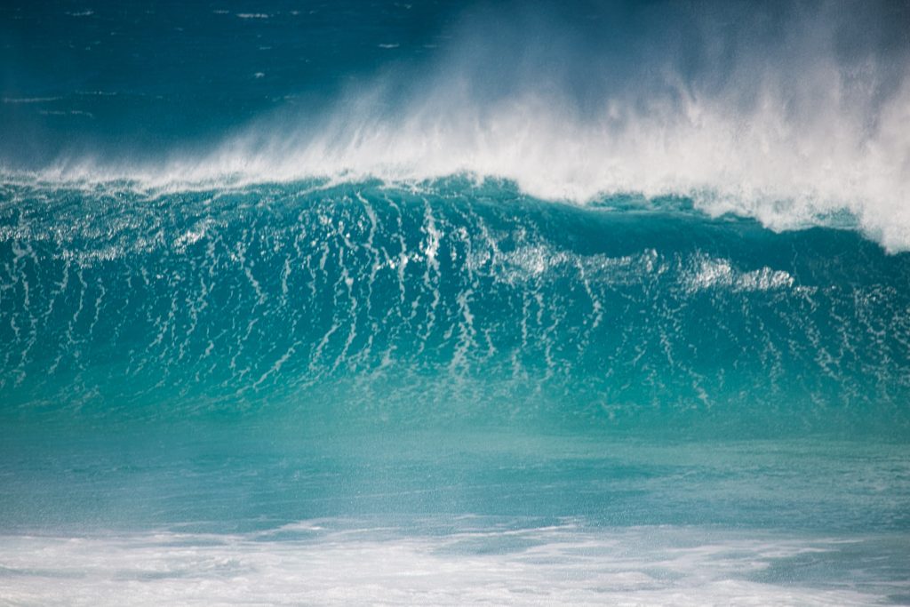 A large wave crest breaks.