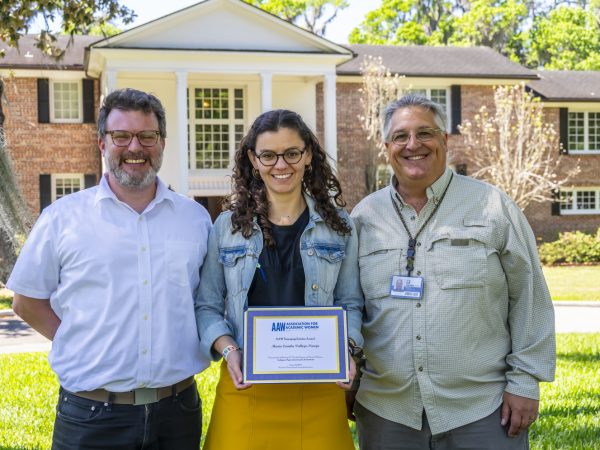 Maria Vallejo-Pareja holds her certificate and stands with her co-advisors David Blackburn and Jonathan Bloch.