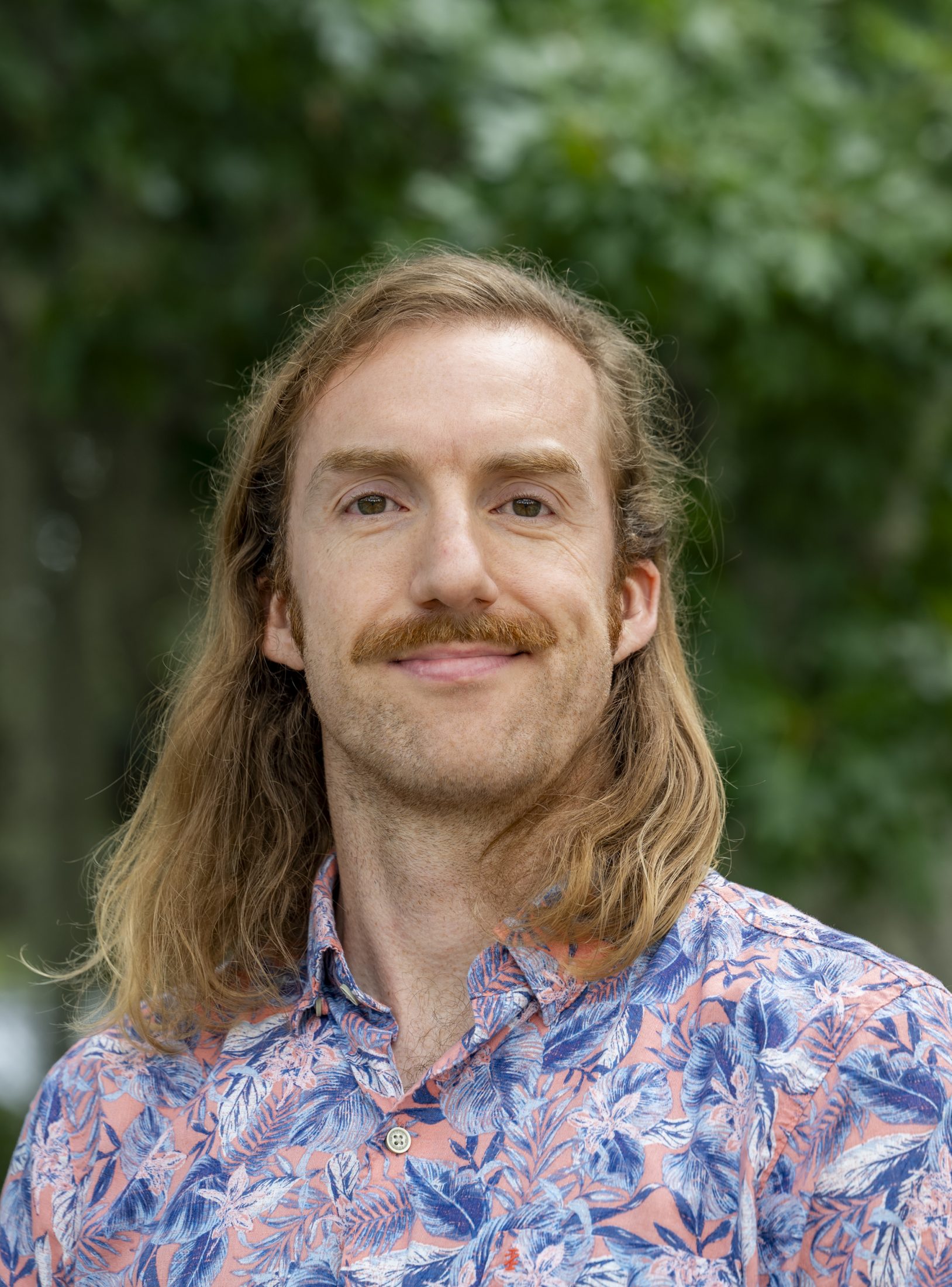 Person standing outside smiling for the camera. 