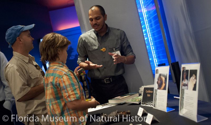 visitors talk with a researcher about bats