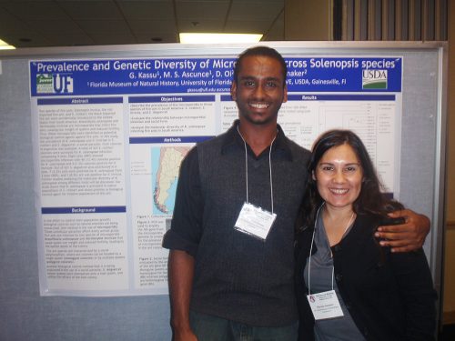 Researcher and student presenting poster