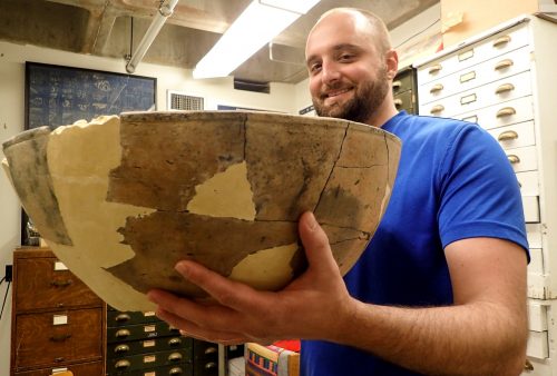 Man holding a large pottery bowl