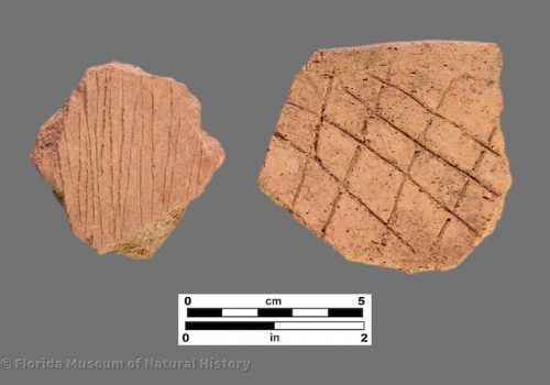 2 sherds of pottery with linear and cross-hatched designs