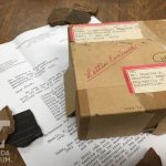 A small cardboard box, typewritten letter, and pottery sherds