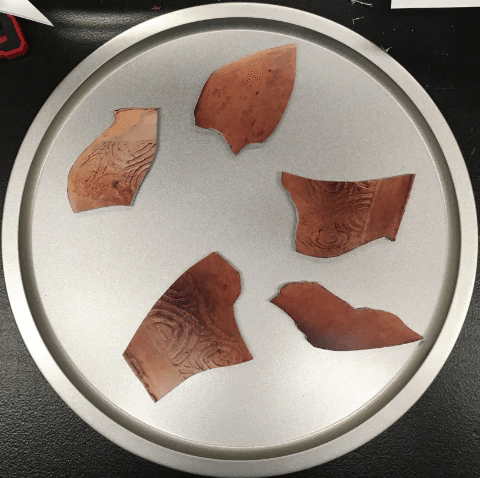 child's puzzle of a pre-Columbian vessel coming together
