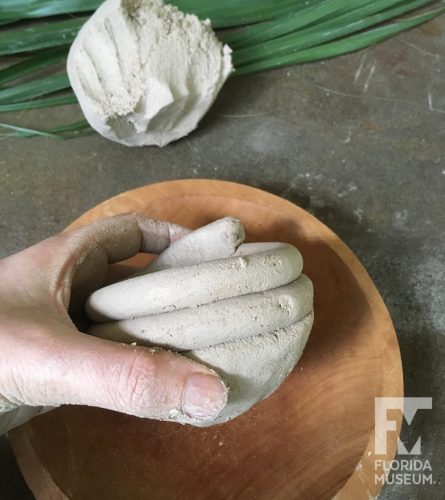 A small pot with visible coils added to top