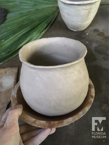 pot sitting in wooden bowl