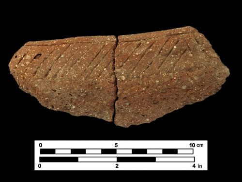 fragment of pottery on black background