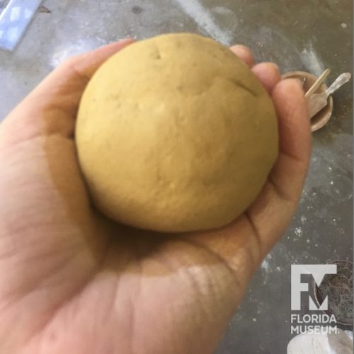 ball of clay in hand