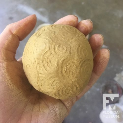 ball of clay with stamped design