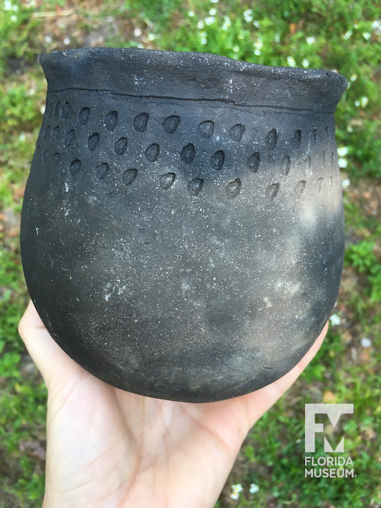 Blackened pot with punctations