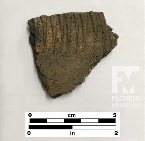 Pottery sherd with zig-zag line decoration and small pits