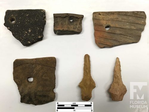 sherds, each with one small round hole, and two stone drilling tools