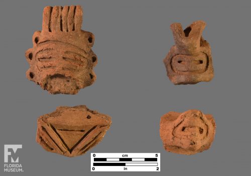 Formal artifact photo of four adorno head effigies.