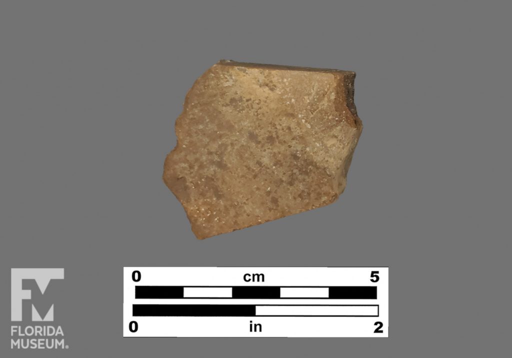 Formal artifact photo of an undecorated sherd.