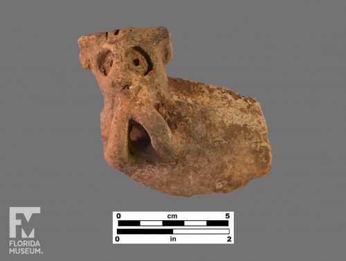 Formal artifact photo of an animalistic Chicoid adorno with attached handle