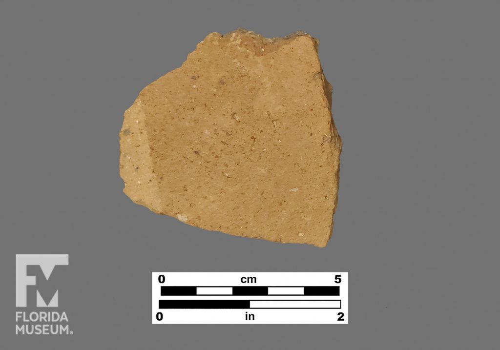 Formal artifact photo of an undecorated sherd.