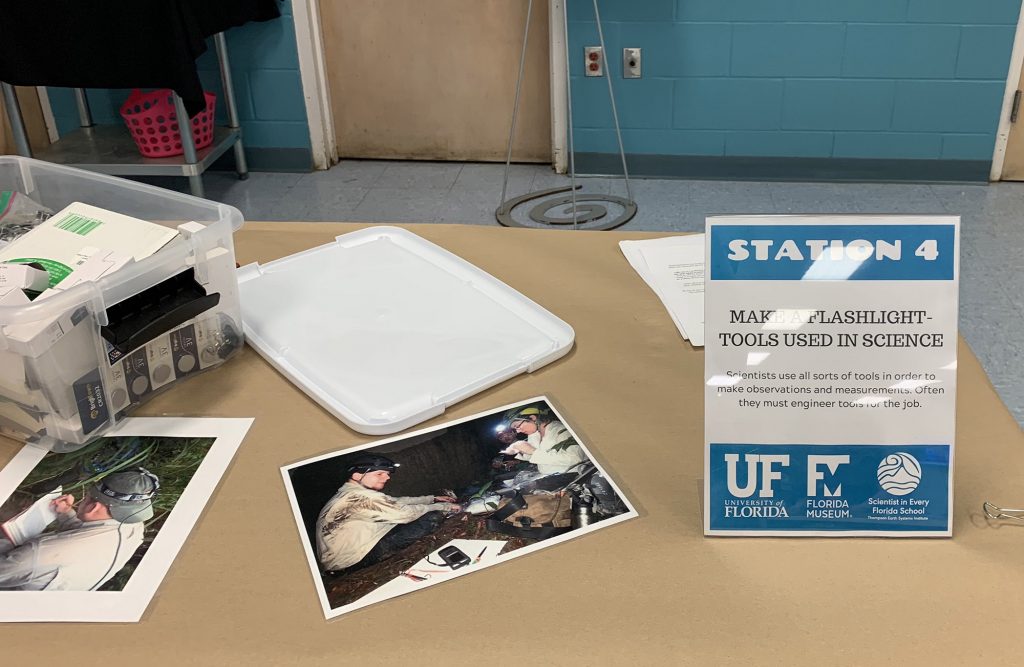 a table with signage and instructions for a science project