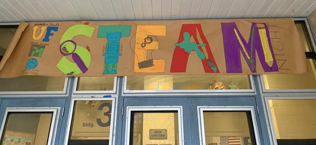 student painted banner featuring the letters for STEAM