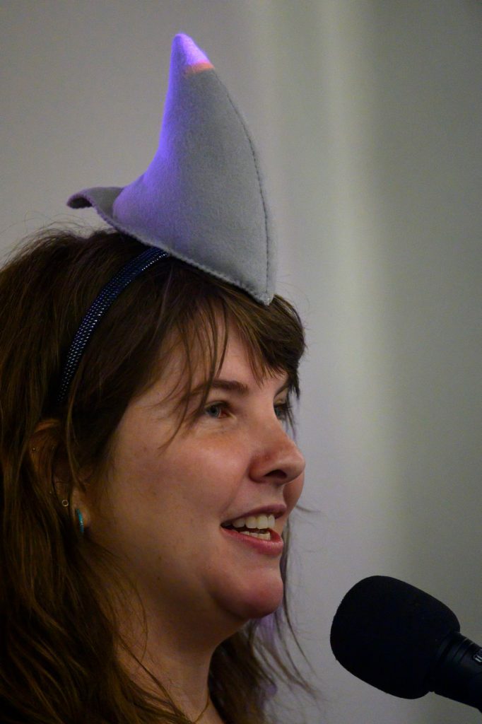 woman wearing a headband with a large shark fin on it