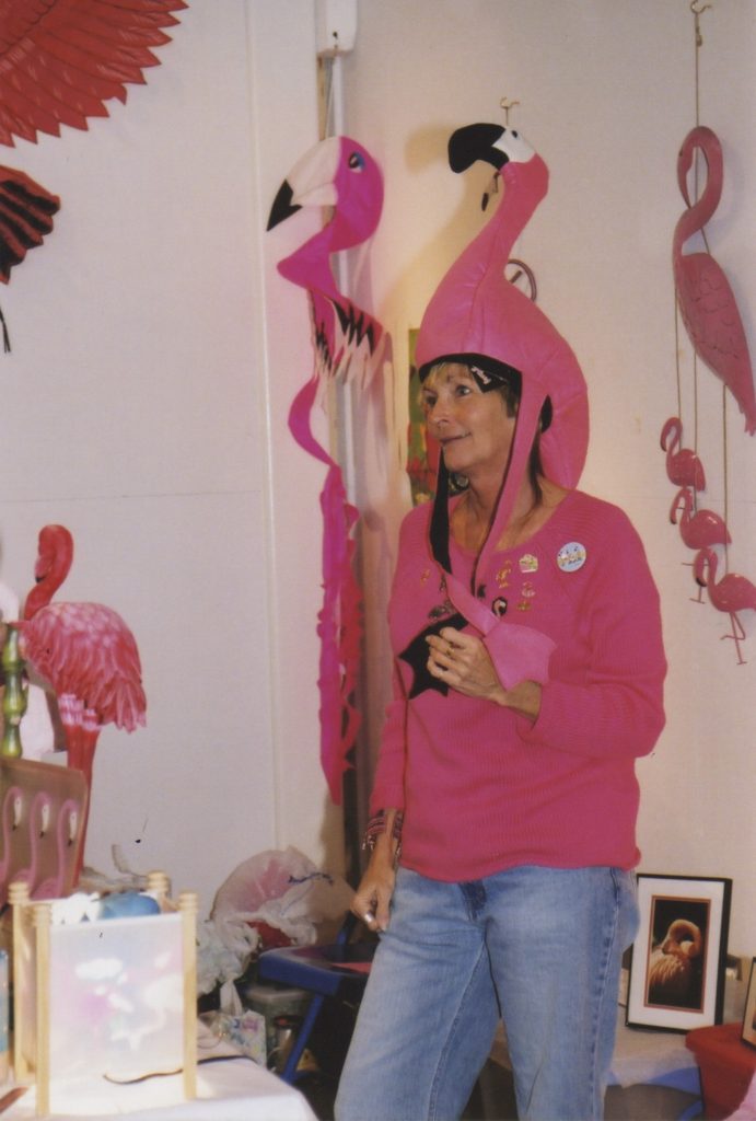 A woman wearing a flamingo hat.