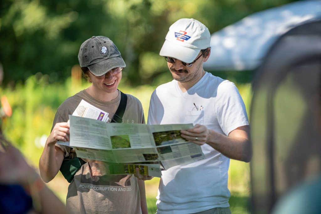 two visitors reading an information pamphlet