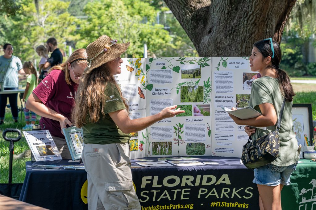 guests standing in front of the Florida State Parks display table
