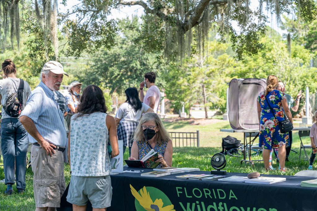 guests look at books and displays at the Florida Wildflower display tables