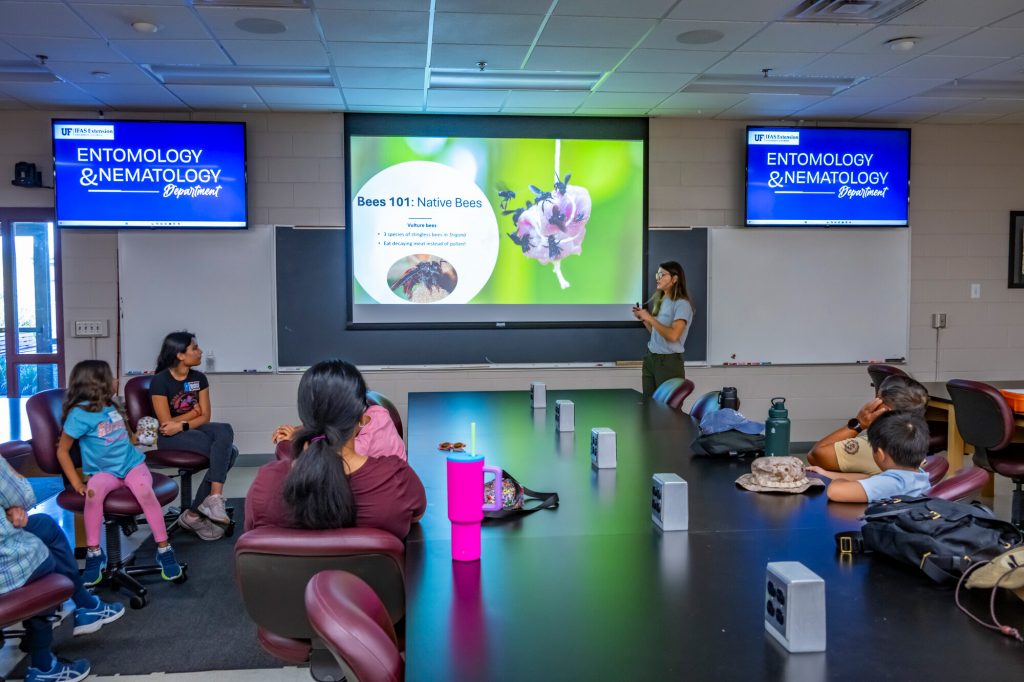 Kaitlin Deutsch, in a classroom speaking to participants in the Family Discovery Camp Bees.