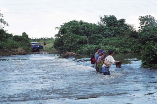 three people standing is waist-deep water