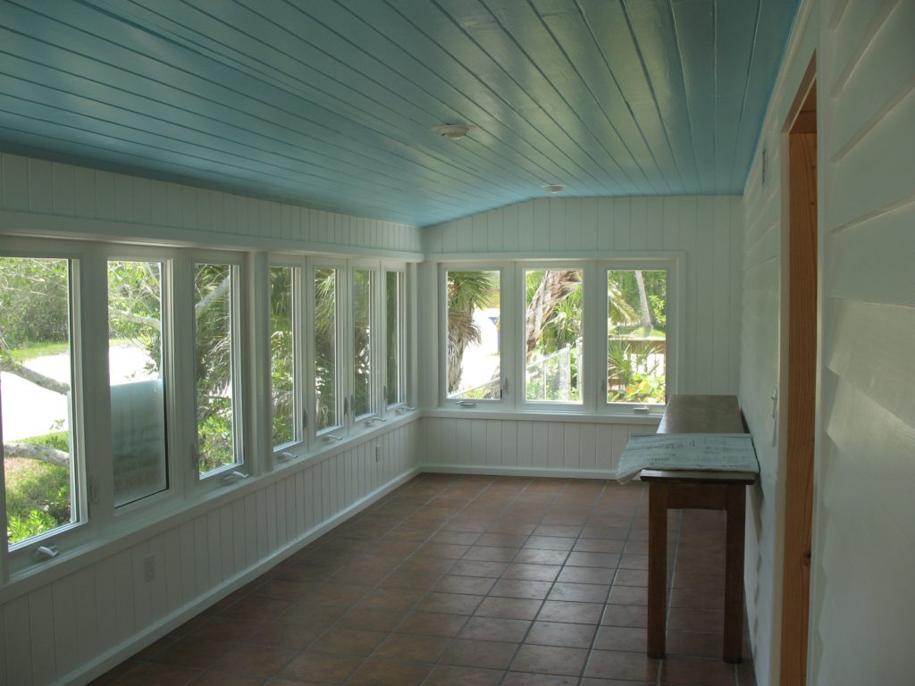 the inside of the front porch, stone floor and a blue ceiling