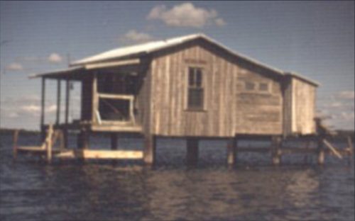 wooden house on stilts over the water