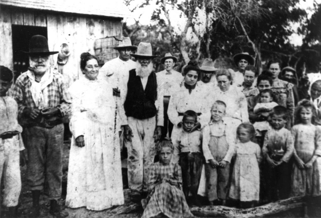 black and white photos of a group of people, men woman and children