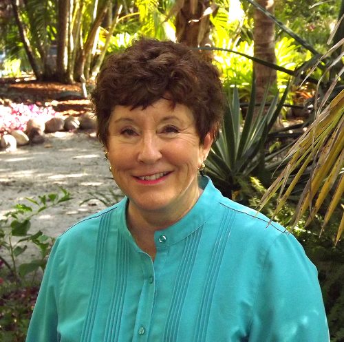 portrait of a woman in front of a garden