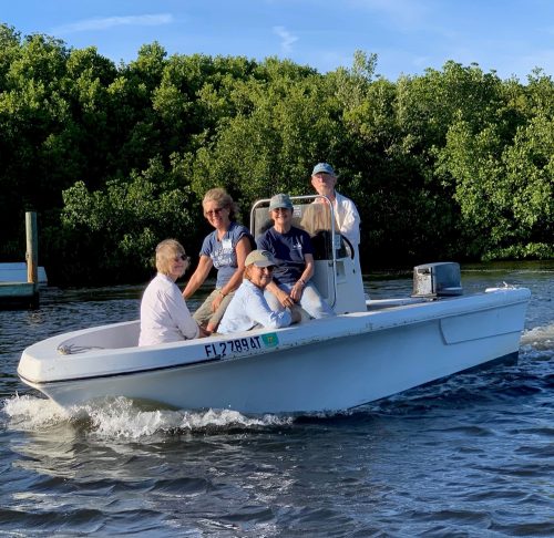 Ed Chapin, Kahla Gentry, Melonnie Hartl, Nancy O’Brien and Cindy Bear in a white motor boat.