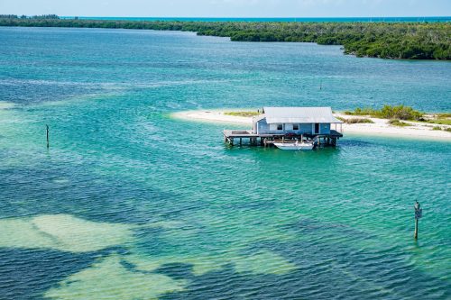 aerial view of house on stilts surrounded by water