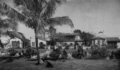 home with palm trees in front