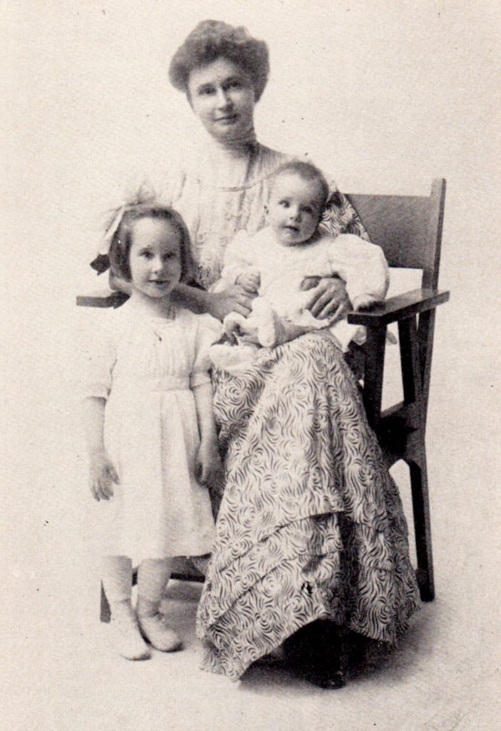 group photo of woman and two young children
