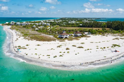 aerial photograph of island with white sand beach