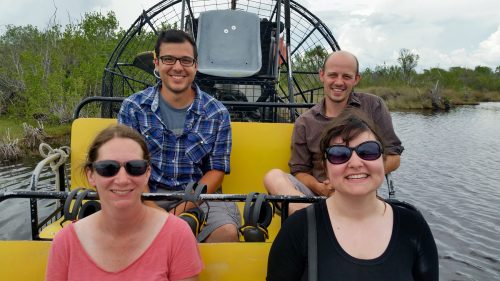 group photo of four people on boat